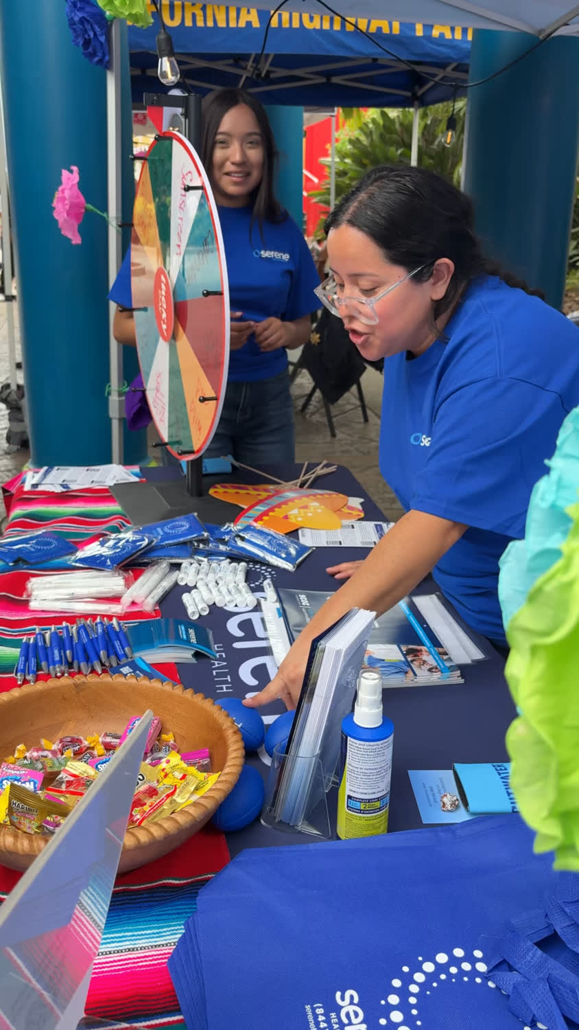 A MindSet and Serene Health Group team member handing out resources at a community health fair